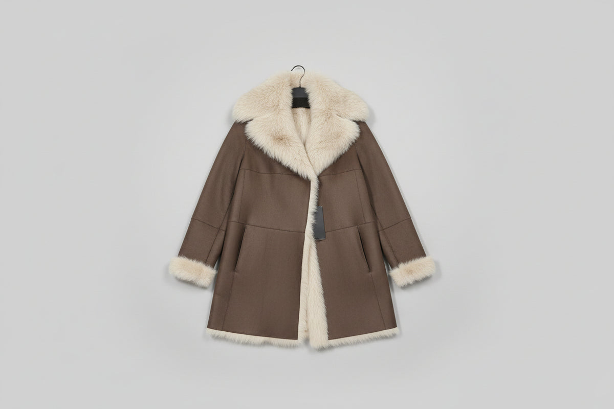 Découvrez l'élégance intemporelle de ce manteau en mouton retourné aux poils longs, véritable pièce maîtresse de votre garde-robe hivernale. Confectionné en peau glacée chocolat, il conjugue luxe et confort avec son design réversible qui offre deux styles en un. La capuche généreuse et les poils longs créent une silhouette enveloppante et sophistiquée, parfaite pour les journées froides. Polyvalent et incontournable, ce manteau transforme chaque sortie en moment de prestige.